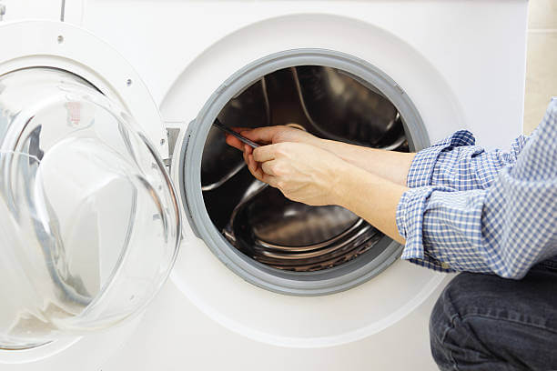 handyman repairing a washing machine